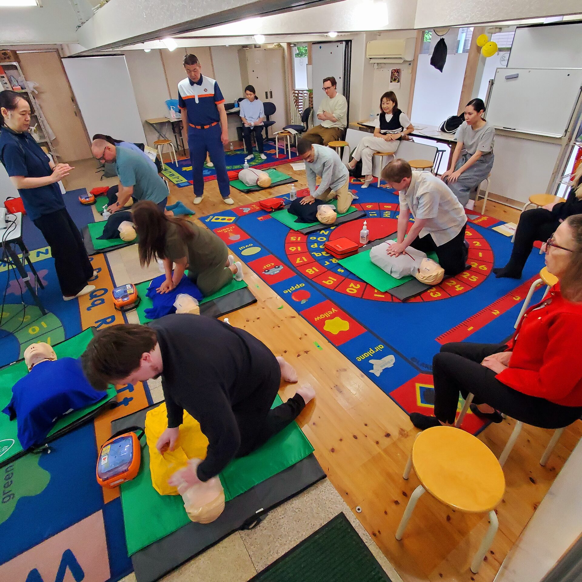 MLS staff practicing CPR during first aid course