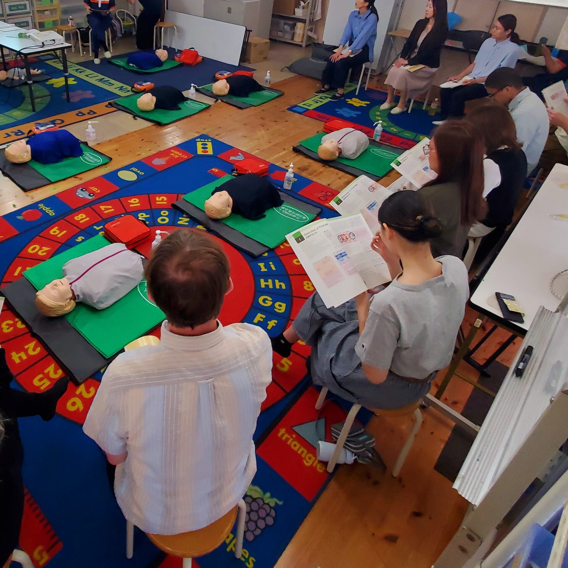 MLS staff reviewing first aid instruction materials