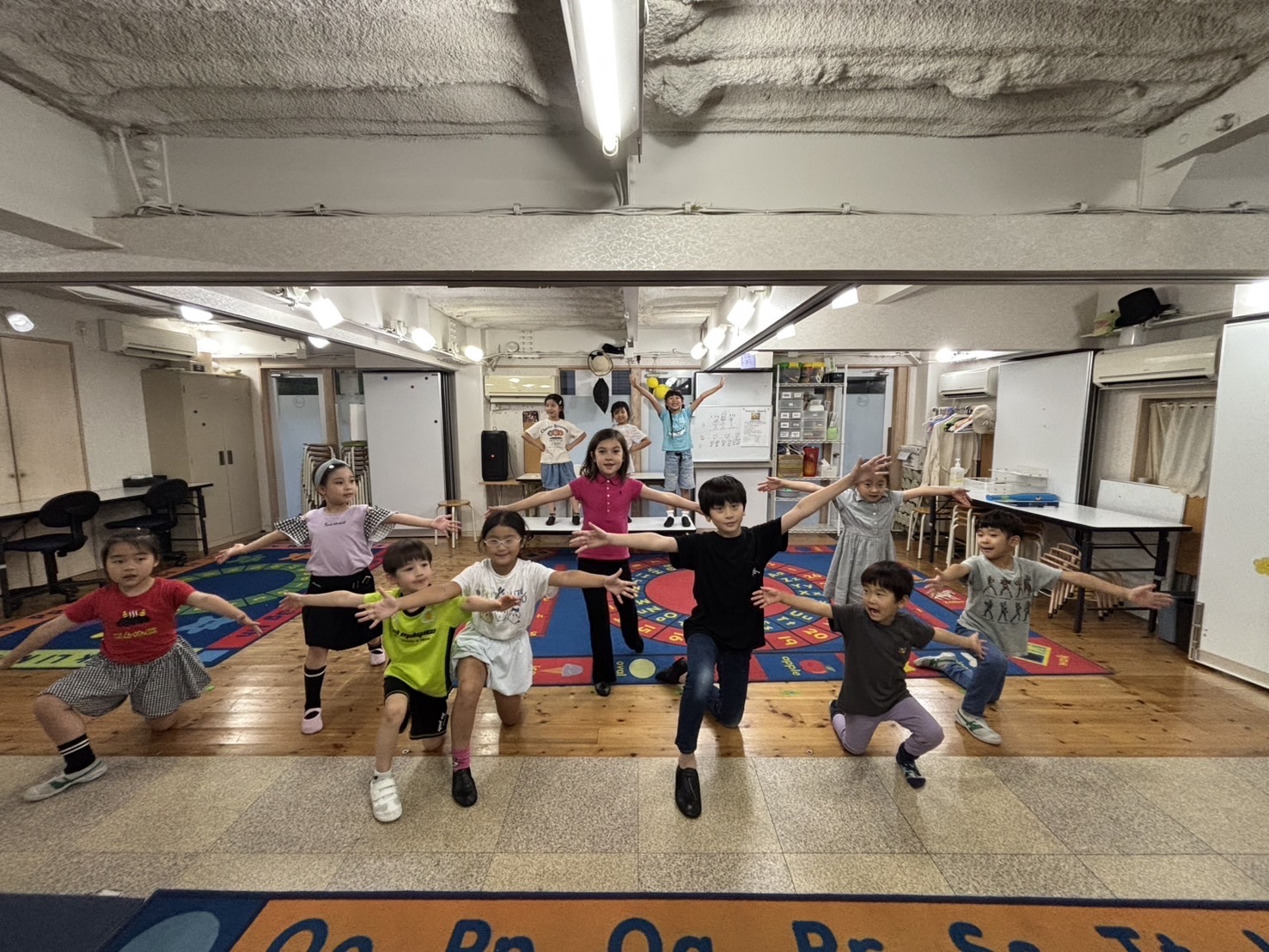 Mini Production students energetically rehearsing Pinocchio with big smiles